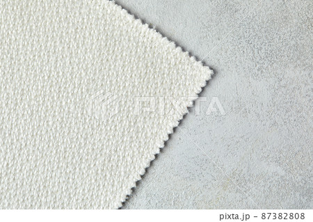 Knitted texture. Texture of jacquard fabric with gray pattern. Crochet mosaic pattern. 87382808