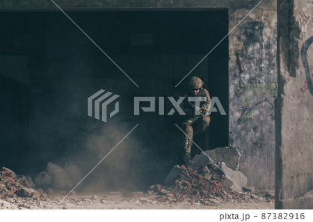 A bearded soldier in uniform of special forces in a dangerous military action in a dangerous enemy area. Selective focus A bearded soldier in uniform of special forces in a dangerous military action in a dangerous enemy area. Selective focus 87382916