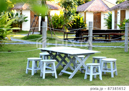 Grey table and chair in the garden Grey table and chair in the garden 87385652