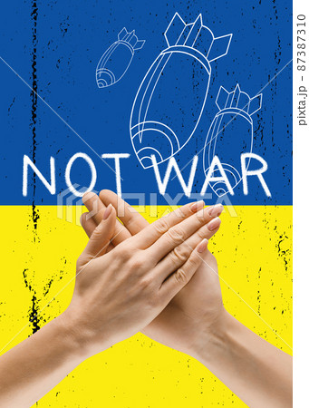 Conceptual collage with human hands on blue yellow flag of Ukraine background. No war, peace in the world, stop bomb attacks 87387310