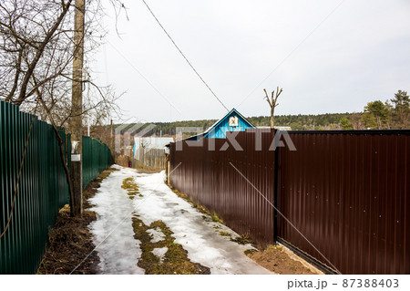 Alley between summer cottages, metal fences from corrugated board 87388403