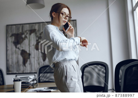 Woman in the office is talking on the phone Woman in the office is talking on the phone 87388997