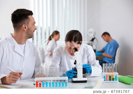 Medical students with microscope in modern laboratory Medical students with microscope in modern laboratory 87391707