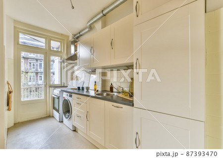 Kitchen in classic white with all the necessary equipment for use Kitchen in classic white with all the necessary equipment for use 87393470
