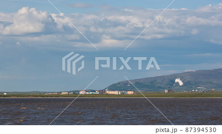 Summer Arctic landscape. View from the sea to colorful buildings in the tundra 87394530