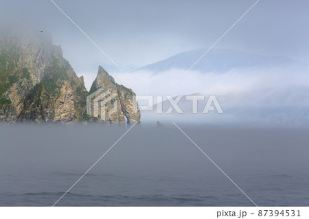 Picturesque summer sea Arctic landscape. View of the rocky promontory and mountains. Picturesque summer sea Arctic landscape. View of the rocky promontory and mountains. 87394531