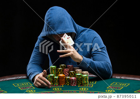 Poker player showing a pair of aces 87395011