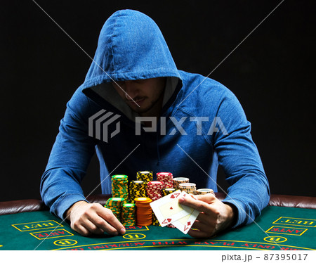 Poker player showing a pair of aces Poker player showing a pair of aces 87395017