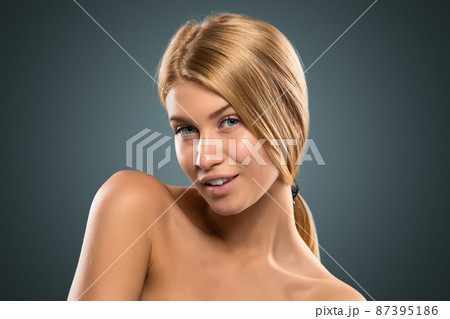 Portrait beautiful blond woman with long hair and blue eyes 87395186