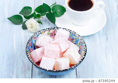 Turkish delight or lokum confection rose and lemon flavored with cup of coffee and rose, horizontal Turkish delight or lokum confection rose and lemon flavored with cup of coffee and rose, horizontal 87395244