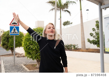 Girl at bus stop Girl at bus stop 87396408