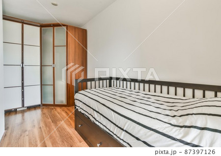 Compact room for one person with a comfortable bed and soft linens Compact room for one person with a comfortable bed and soft linens 87397126