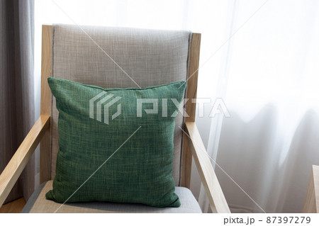 Green pillows in  chair,  Curtains background 87397279