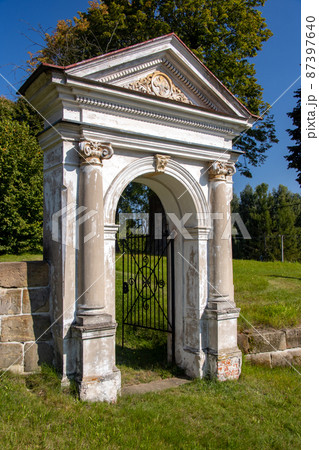 Classicist gate at the entrance to a country cemetery, Czechia 87397640