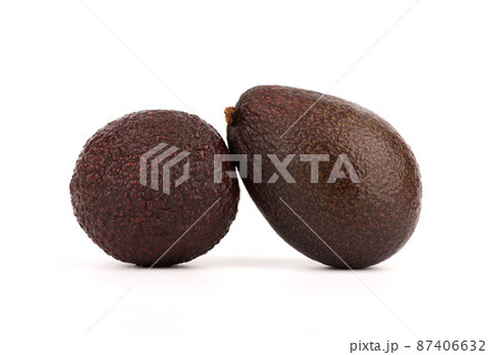 Close-up of two ripe avocados on a white background. 87406632