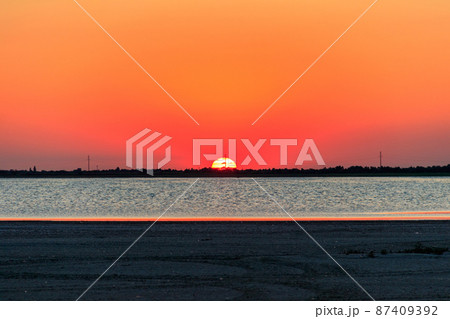 Beautiful orange sunset over a salt lake 87409392