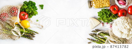 Various Italian fresh food in eco-friendly package on white marble background. 87413782