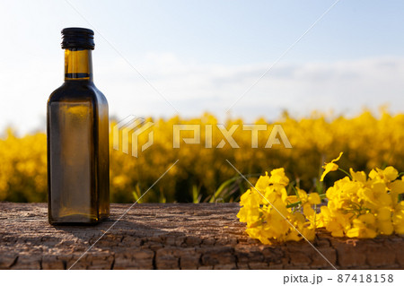 Oil bottle on the background of oilseed rape. Oil bottle on the background of oilseed rape. 87418158