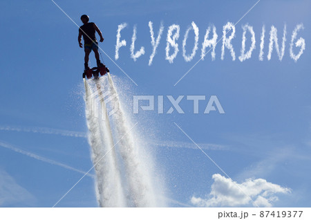 Man posing at new flyboard - the inscription "flyboard" Man posing at new flyboard - the inscription "flyboard" 87419377