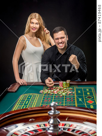Couple playing roulette wins at the casino. Couple playing roulette wins at the casino. 87419468
