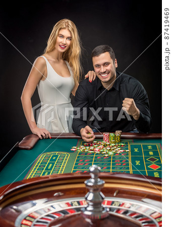 Couple playing roulette wins at the casino. Couple playing roulette wins at the casino. 87419469