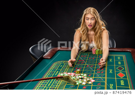 Young pretty women playing roulette wins at the casino Young pretty women playing roulette wins at the casino 87419476