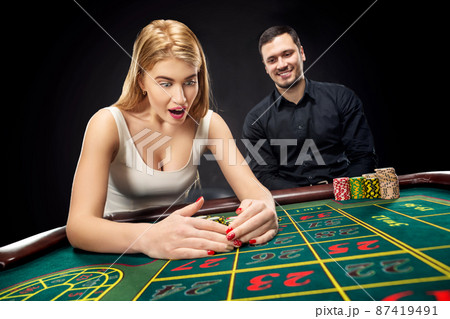 Couple playing roulette wins at the casino. Couple playing roulette wins at the casino. 87419491