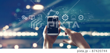 Smart industry concept with person using smartphone Smart industry concept with person using smartphone 87420744