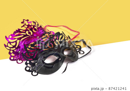 Multicolor carnival mask on yellow-white background. Multicolor carnival mask on yellow-white background. 87421241