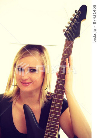 Woman with electrical guitar and vinyl record. 87421408