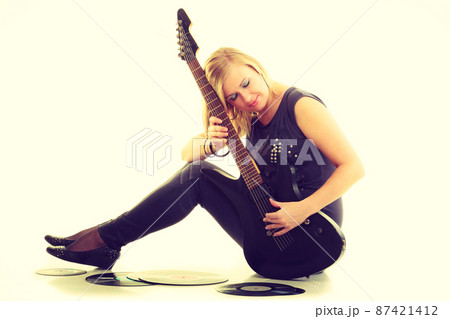Woman with electrical guitar and vinyl record. Woman with electrical guitar and vinyl record. 87421412