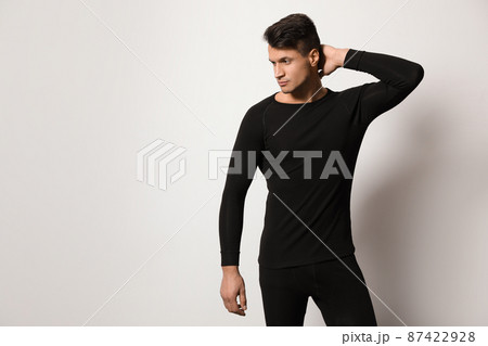 Man wearing thermal underwear on light grey background. Space for text 87422928