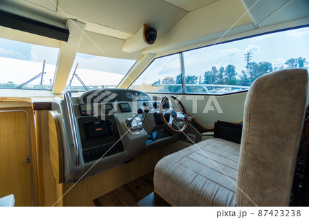 Luxury cabin cruiser out on river. No one sitting in captains seat 87423238