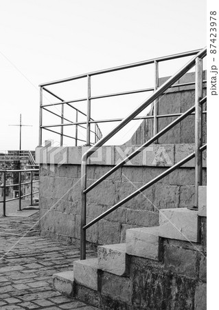Outdoor stairs with metal handrails. Black and white photography. 87423978