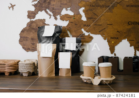 Disposable paper cups with coffee for takeaway food. Packages with coffee on counter for self-service, drink to go. Disposable paper cups with coffee for takeaway food. Packages with coffee on counter for self-service, drink to go. 87424181