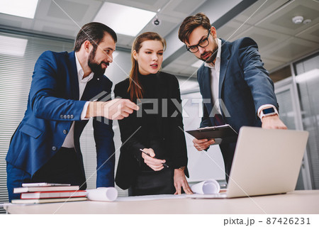 Group of businesspeople using laptop for discussing business project Group of businesspeople using laptop for discussing business project 87426231