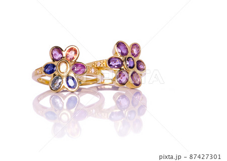 Ruby, Amethyst, blue, purple, green, yellow and orange sapphire Jewel or gems ring on white background with reflection. Collection of natural gemstones accessories. Studio shot 87427301