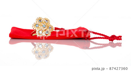 Blue sapphire Jewel or gems ring on red velvet bag. Collection of natural gemstones accessories. Studio shot Blue sapphire Jewel or gems ring on red velvet bag. Collection of natural gemstones accessories. Studio shot 87427360
