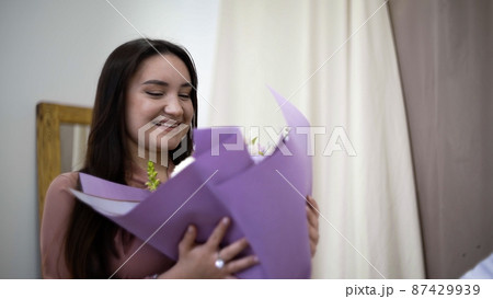 Close-up of a girl giving a bouquet of beautiful flowers. Flowers 87429939