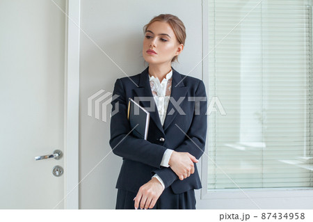 Successful business woman wearing black suit portrait Successful business woman wearing black suit portrait 87434958