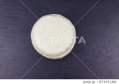 Soft Adyghe cheese on black slate background. Top view 87435188