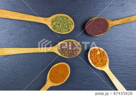 Set of different aromatic spices on black slate. Top view Set of different aromatic spices on black slate. Top view 87435626