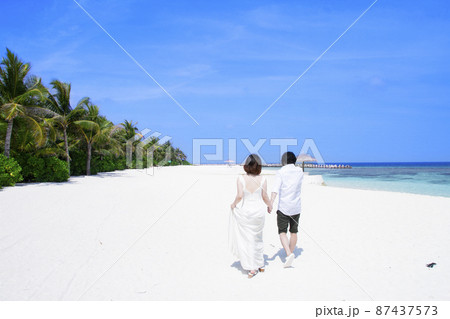 新婚旅行で手を繋いで歩くふたり 新婚旅行で手を繋いで歩くふたり 87437573