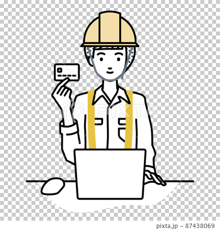 A woman at a construction site sitting at a desk and using a PC while holding a credit card 87438069