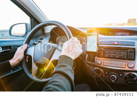 Gps device map system. Global positioning system on smartphone screen in auto car on travel road. GPS vehicle navigator driver device. Gps device map system. Global positioning system on smartphone screen in auto car on travel road. GPS vehicle navigator driver device. 87439151