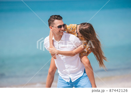 Little girl and happy dad having fun during beach vacation Little girl and happy dad having fun during beach vacation 87442126
