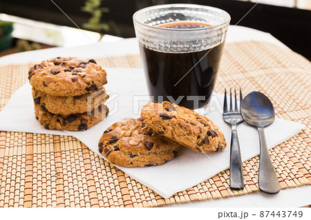 cookies with chocolate and hazelnuts and coffee are on table 87443749