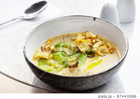 Close-up shot of a delicious cream soup with vegetables, top view. 87443996