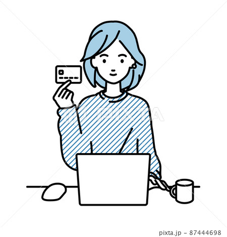 デスクで座ってPCを使いながらクレジットカードを手に持っているリモートワークの女性 87444698