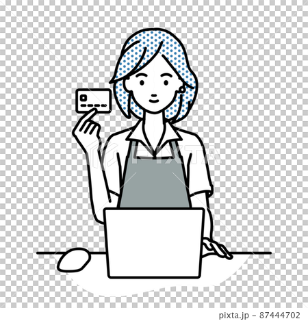 A woman in a cafe clerk sitting at a desk and using a PC while holding a credit card 87444702
